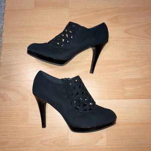 Black round toe laser cut zip ankle heels by Impo